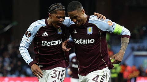 Aston Villa's Ezri Konsa (R) celebrates scoring the team's fourth goal with Leon Bailey during the UEFA Europa League, quarter final second-leg football match between Aston Villa and Bologna on April 16, 2026.