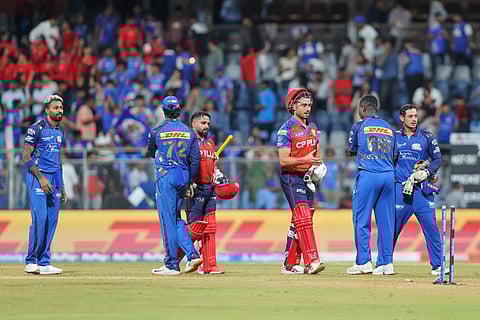 Punjab Kings players shake hands with Mumbai Indians players