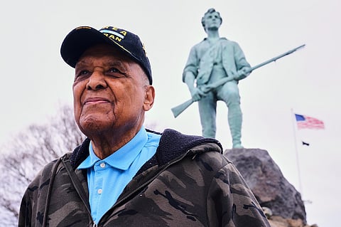 Revolutionary War re-enactor Charles Price, 95, who for decades portrayed enslaved Minuteman Prince Estabrook, poses for a portrait near the Minute Man statue, Monday, April 13, 2026, in Lexington, Mass. 