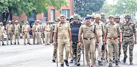 Police personnel keep a vigil as a Samajwadi Party (SP) delegation approaches DND flyway to meet factory workers, in Noida, Gautam Buddha Nagar district, Uttar Pradesh, Friday, April 17, 2026.