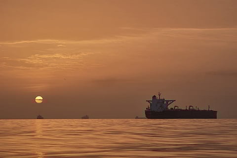The sun rises behind tankers anchored in the Strait of Hormuz off the coast of Qeshm Island, Iran, Saturday, April 18, 2026. 