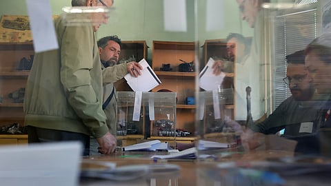 A man casts his vote during an early election at a polling station in Sofia on Sunday, April 19, 2026.