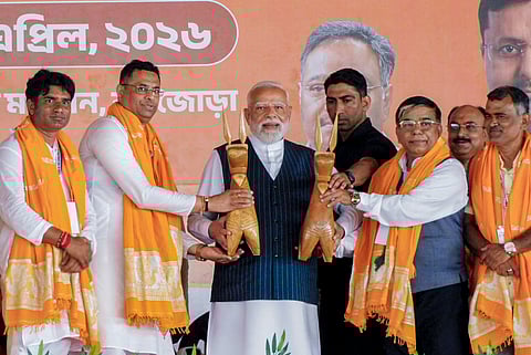 Prime Minister Narendra Modi being presented a memento by BJP leaders during the 'Vijay Sankalp rally' ahead of West Bengal Assembly elections, in Purulia, Sunday, April 19, 2026.