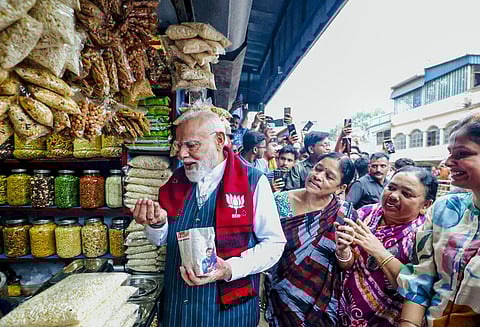 Prime Minister Narendra Modi tries 'jhalmuri'', street snack made of puffed rice.