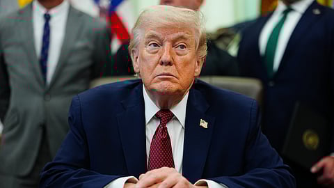 US President Donald Trump listens in the Oval Office of the White House, Saturday, April 18, 2026, in Washington.
