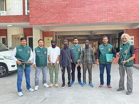 Police with the four accused