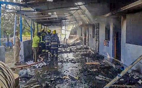 Firefighters at the site after a blast in a firecracker manufacturing unit, at Kattanarpatti in Virudhunagar