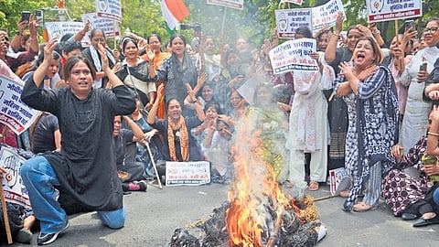 Congress workers protest outside the BJP headquarters on Sunday, demanding implementation of women’s quota on existing Lok Sabha strength