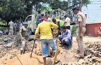 Workers plugging the pipeline leak in Jagatsinghpur town on Sunday