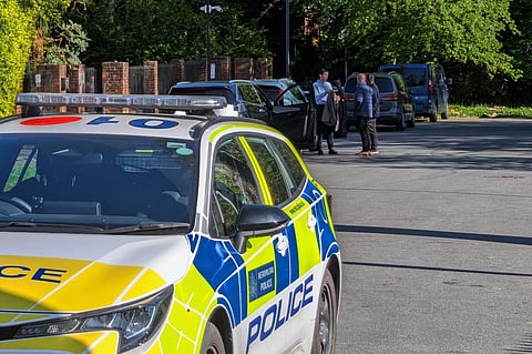 Police officers patrol at a cordon near Kenton United Synagogue in Harrow, a suburb of London, Sunday, April 19, 2026.
