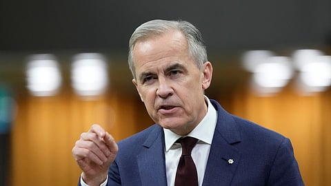 FILE - Canada Prime Minister Mark Carney rises during Question Period on Parliament Hill in Ottawa, April 15, 2026