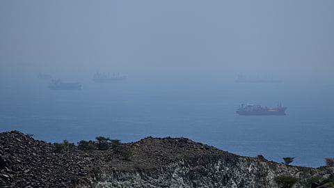 Tankers and bulk carriers anchored in the Strait of Hormuz, Saturday, April 18, 2026