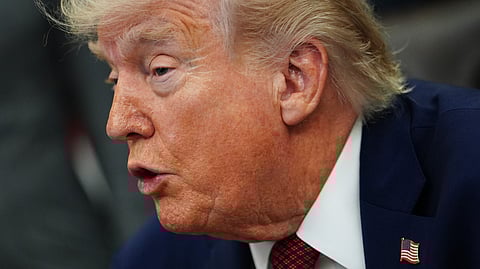 President Donald Trump listens to speeches before signing an executive order in the Oval Office of the White House, Saturday, April 18, 2026, in Washington. 