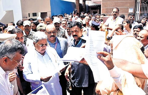 Chief Minister Siddaramaiah receives petitions from the public near his house in Mysuru on Tuesday.