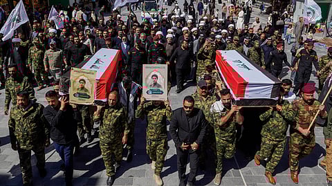 Members of the Popular Mobilization Forces attend a funeral for colleagues who were killed in a US airstrike in Anbar, in Najaf, Iraq, Wednesday, April 1, 2026.