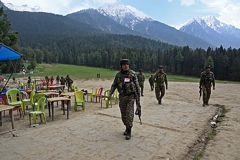 Security personnel inspect the site in the aftermath of an attack as food stall chairs lie empty in Pahalgam, about 90km (55 miles) from Srinagar on April 23, 2025.