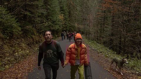 Ukrainian combat medic Anastasia Podobailo, with her colleague and husband Mykola Yasinenko, walk with others to visit Lake Synevyr during the RePower programme, a mountain retreat designed to support Ukrainian military medics' psychological recovery and mental well-being in Ukraine's western Zakarpattia region on October 27, 2025, amid the Russian invasion of Ukraine.