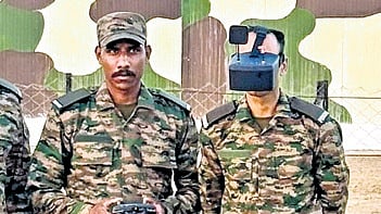 Soldiers operate an FPV drone through an obstacle course during training at an Army drone lab