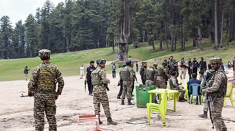 In this photo from April 23, 2025, security personnel inspect the site following the terrorist attack that took place in Baisaran Valley in Pahalgam.