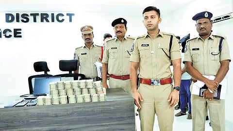 Nalgonda SP Sharath Chandra Pawar displays the Rs 2.42 crore cash recovered from the accused involved in the SBI Devarakonda branch fraud case