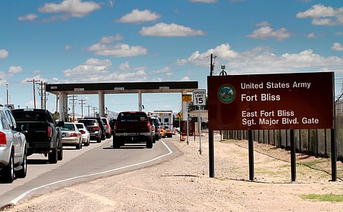 Cars wait to enter Fort Bliss, Texas, Sept. 9, 2014. 