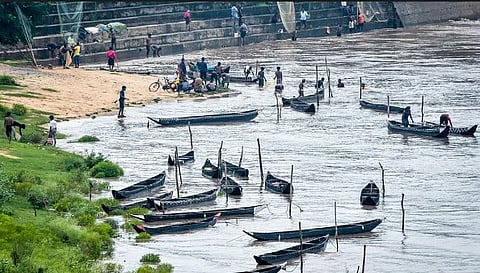 People fishing in the floodwaters of Mahanadi at Mundali barrage in Cuttack 