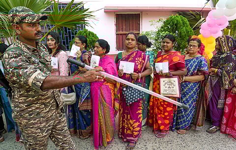 Purba Medinipur: A security personnel monitors voters during polling in the first phase of the West Bengal Assembly elections, at a polling station in Nandigram, Purba Medinipur, Thursday, April 23, 2026. 