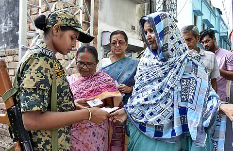 Security check underway at a polling station during voting in the first phase of the West Bengal Assembly elections, in Murshidabad.