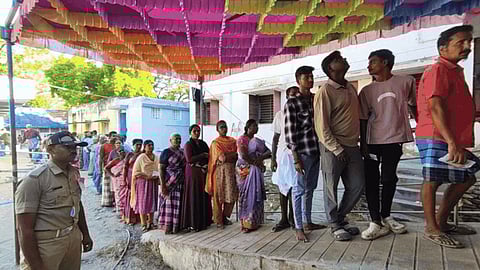  The people are seen waiting in a queue to cast their votes for the assembly election in a polling booth at in Madurai on Thursday
