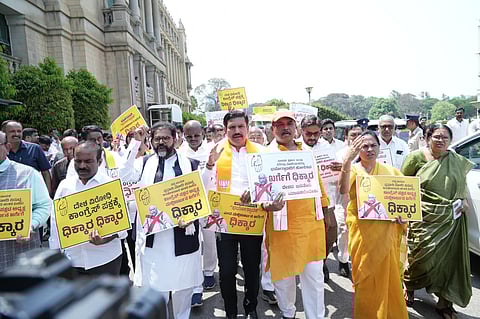 BJP members hold a protest condemning Congress President Mallikarjun Kharge at Vidhana Soudha in Bengaluru on Thursday, April 23, 2026.
