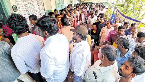 Voters queue up outside a polling station to vote on Thursday.