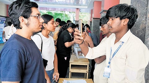Students appearing for CET get scanned before entering the exam hall at the PU College in Seshadripuram  on Thursday.