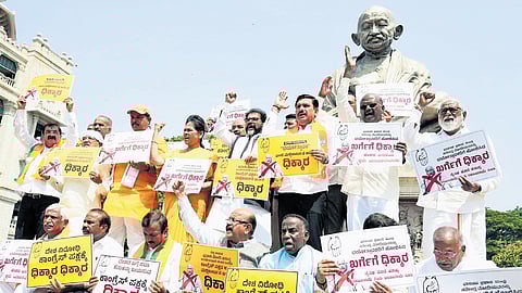 BJP leaders protrest against All-India Congress Committee president Mallikarjun Kharge for his recent remarks on Prime Minister Narendra Modi, in Vidhana Soudha in Bengaluru on Thursday.