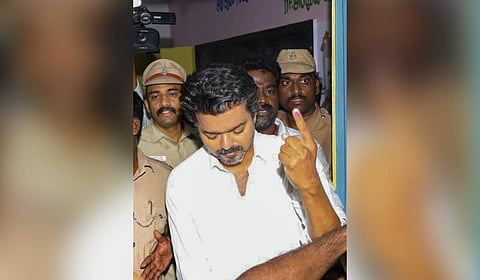 Tamilaga Vettri Kazhagam (TVK) chief Vijay shows his ink-marked finger after casting a vote in the Tamil Nadu Assembly elections at a polling station in Chennai.