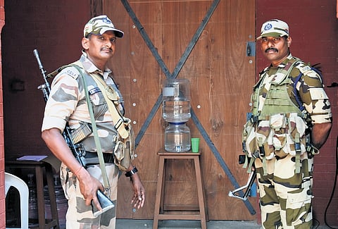 Security personnel guard a strongroom at Anna University in Chennai where EVMs from south Chennai constituencies are stored