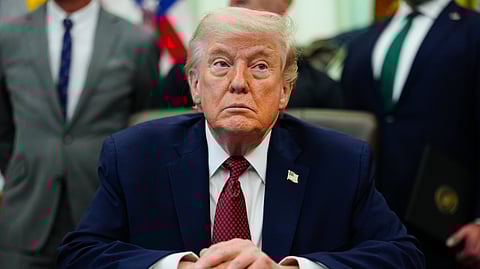 President Donald Trump listens in the Oval Office of the White House, Saturday, April 18, 2026, in Washington.