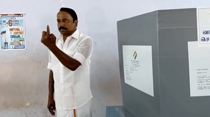 TVK leader and candidate from Gopichettipalayam constituency, KA Sengottaiyan casts his vote and shows his inked finger, at a polling station in Erode.