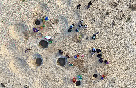 Women collect drinking water and carry it for over two km in scorching heat across a broken bridge at R Pudhupattinam near Aranthangi in Pudukkottai district.