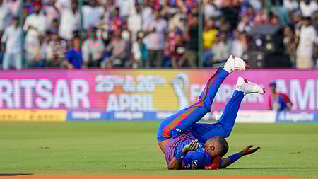 Delhi Capitals' Lungi Ngidi loses balance after an unsuccessful catch attempt during the Indian Premier League (IPL) 2026 T20 cricket match.