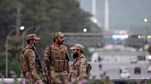 Pakistan’s army soldiers stand guard on a street leading to the Red Zone area after tightened security measures ahead of the expected US–Iran peace talks in Islamabad on April 24, 2026.