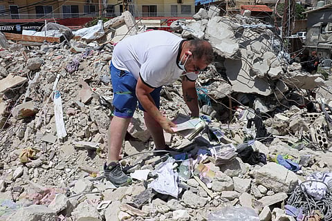 Resident Mohamad Ali Hijazi searches for his belongings amid the rubble of destroyed buildings at a residential area in Tyre on April 23, 2026.