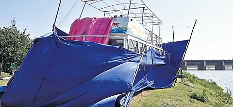 Cruise vessel covered with tarpaulin sheets near the river bank  | parveen negi
