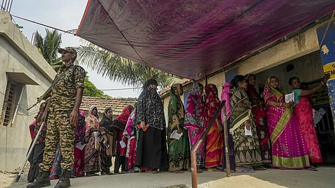 Nandigram: People wait in a queue to cast votes during the first phase of the West Bengal Assembly election, in Nandigram, Purba Medinipur district