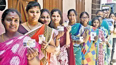Hundreds of voters wait in que to cast their vote at a polling booth at Sacred Heart Mtr. School, Korukkupet, in Chennai on Thursday.