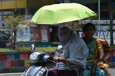 People use umbrella to protect them from scorching heat in Vijayawada