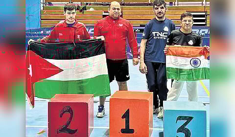 Tushar proudly holds up the Tricolour at a sporting event in which he participated.
