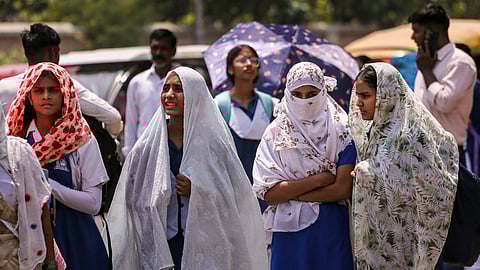 People try to beat the heat on a summer day, in Prayagraj, Monday, April 27, 2026.