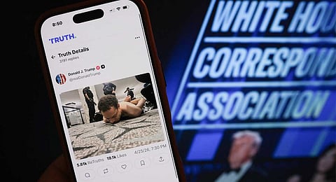 This illustration photo taken in Los Angeles shows a phone with a Truth Social post by US President Donald Trump displaying an image of the alleged suspect in a shooting incident at the White House Correspondents’ Dinner on the ground after being apprehended on April 25, 2026.