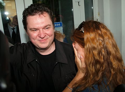 Andrzej Poczobut reacts with his wife Oksana in front of the court building where he was on trial in the town of Grodno, Belarus, Tuesday, July 5, 2011.