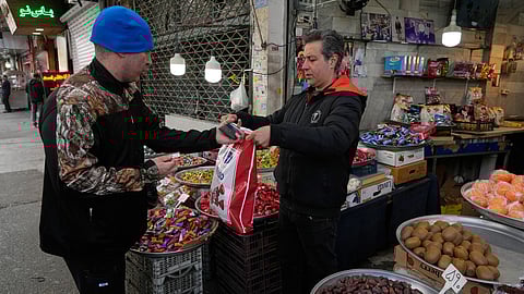 FILE - People conduct their businesses around the traditional grand bazaar of Tehran, Iran, March 29, 2026.